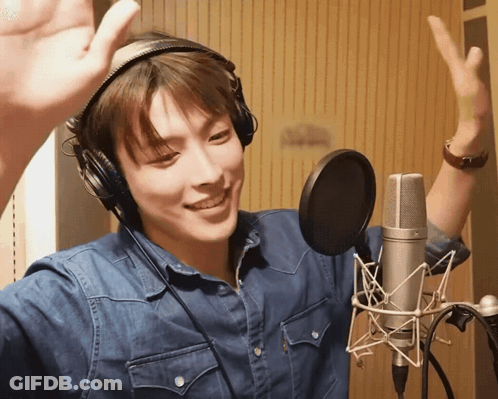 Man In Headphones Hand Up At Microphone GIF