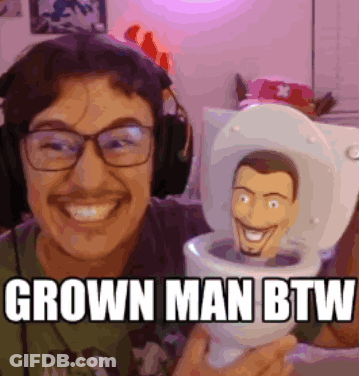 Man In Headphones Holding Toy In Toilet Grown Man BTW GIF
