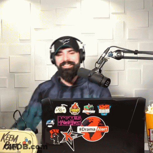Man In Headphones In Front Of Microphone And Laptop Says Drama Alert GIF