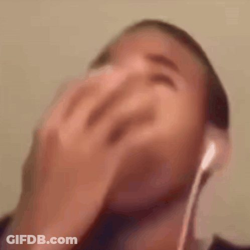 Man In Headphones Laughing Covering Face GIF