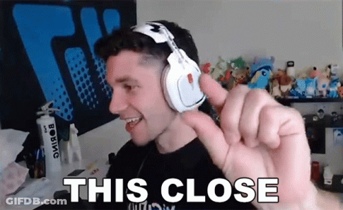 Man In Headphones Making Funny Face Saying This Close GIF