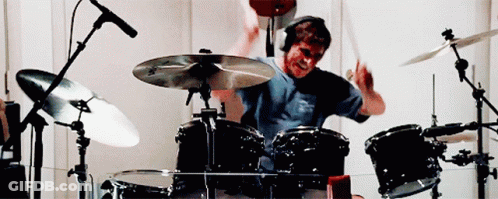 Man In Headphones Playing Drum Set GIF