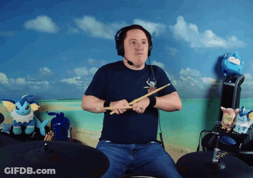Man In Headphones Playing Drums With Stuffed Animals GIF