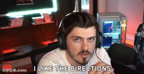 Man In Headphones Saying I Like The Directions In Front Of Red Bull Cooler GIF