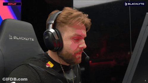 Man In Headphones Sits In Blacklyte Gaming Chair GIF