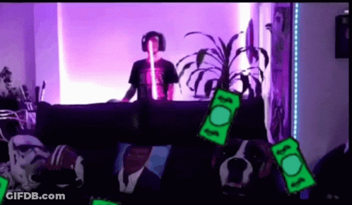 Man In Headphones Sits On Couch Surrounded By Money GIF