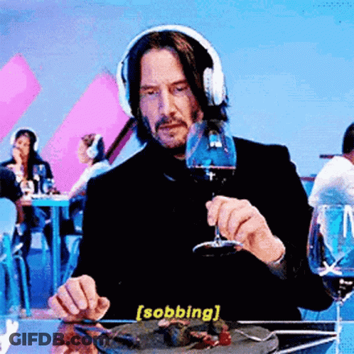 Man In Headphones Sitting At Table With Food And Wine GIF