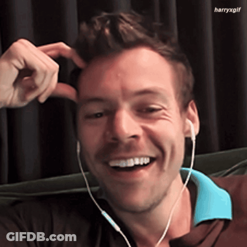 Man In Headphones Smiling And Scratching Head GIF