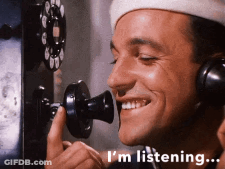 Man In Headphones Smiling Talking On Phone GIF