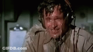 Man In Headphones Sweating In Airplane GIF