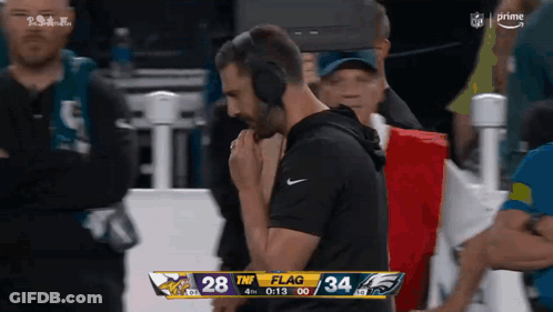 Man In Headphones Watching Vikings Vs Eagles Scoreboard GIF