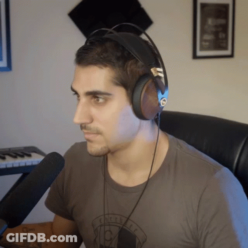 Man In Headphones Wearing Eclectic T-Shirt GIF