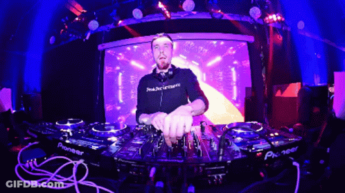 Man In Headphones Wearing Peak Performance Shirt Playing Music GIF