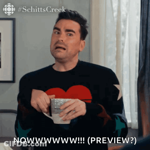 Man In Heart Sweater Holding Coffee Saying Nowwwwwww GIF