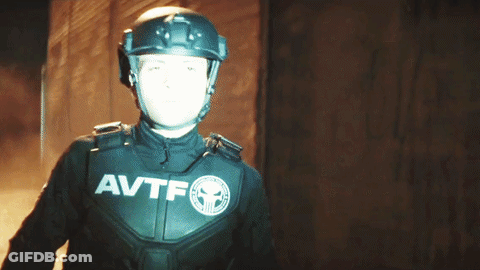 Man In Helmet And AVTF Jacket Holding Up Hand GIF