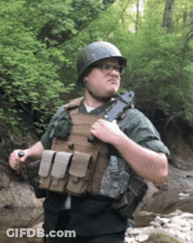 Man In Helmet And Bulletproof Vest Holding Gun GIF