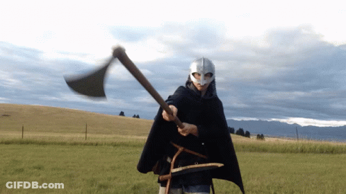 Man In Helmet And Cape Holding Axe GIF