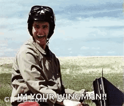 Man In Helmet And Goggles Holding Briefcase And Remote Control In Field GIF