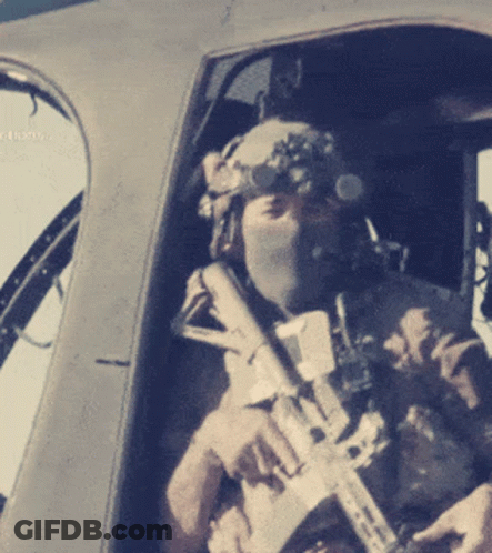 Man In Helmet And Goggles Holding Rifle GIF