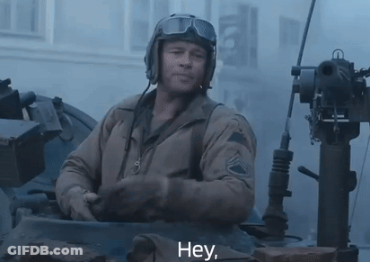 Man In Helmet And Goggles Saying Hey In Tank GIF