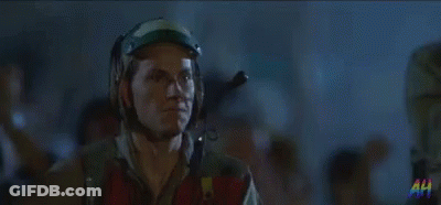 Man In Helmet And Goggles Standing In Crowd GIF