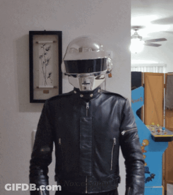 Man In Helmet And Leather Jacket At Arcade Game GIF