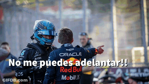 Man In Helmet And Red Bull Shirt Pointing At Another Man GIF