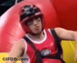 Man In Helmet And Red Tank Top On Red Inflatable Raft GIF