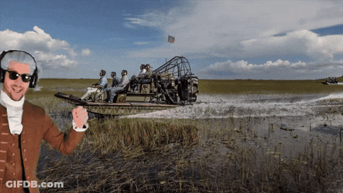 Man In Helmet And Sunglasses In Front Of Boat With People GIF