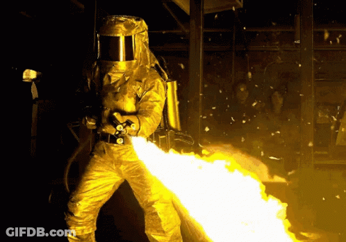 Man In Helmet Holding Flamethrower GIF