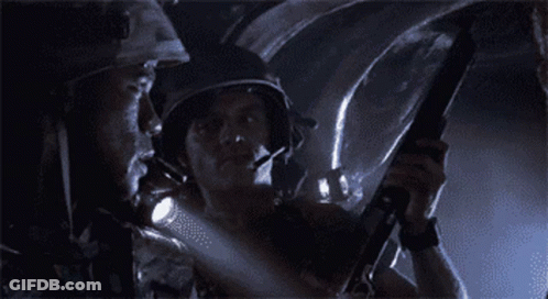 Man In Helmet Holding Gun GIF