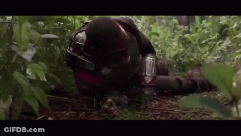 Man In Helmet Laying In Woods GIF