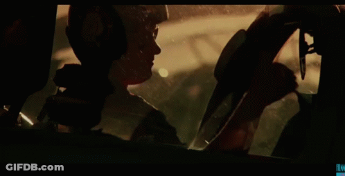 Man In Helmet Looking Out Car Window GIF