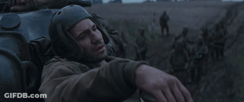 Man In Helmet Lying In Field With Soldiers GIF