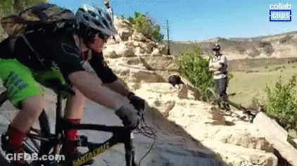 Man In Helmet Riding Bike Down Rocky Trail GIF