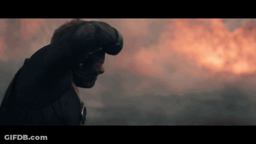 Man In Helmet Standing Before Fire GIF