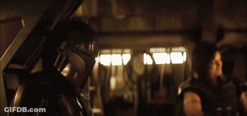 Man In Helmet Standing In Dark Room GIF