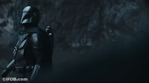 Man In Helmet Standing In Darkness GIF