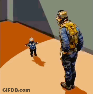 Man In Helmet Standing Next To Child GIF