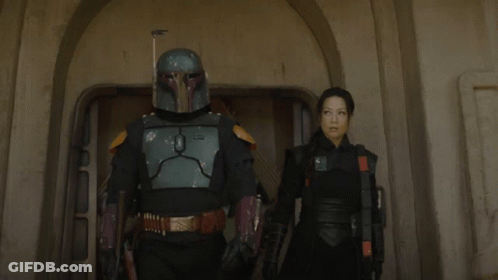 Man In Helmet Standing Next To Woman In Black GIF