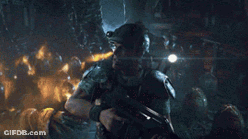 Man In Helmet Stands Before Aliens In Cave GIF