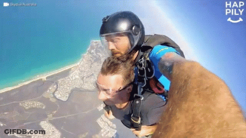 Man In Helmet Taking Mid-Air Selfie Hap Pily GIF