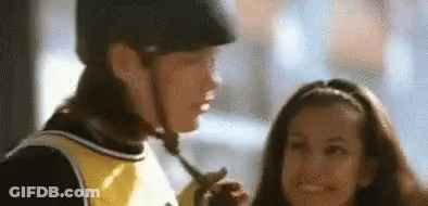 Man In Helmet Talking To Girl Holding Stick GIF