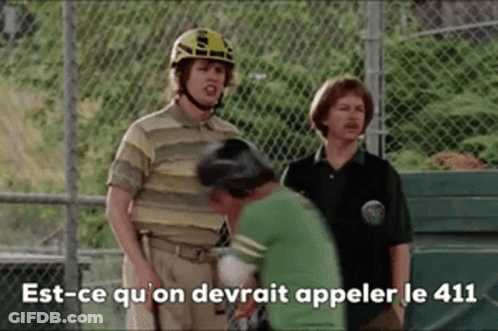 Man In Helmet Talking To Man In Green Shirt GIF