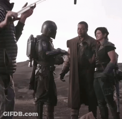 Man In Helmet Talking To Woman In Black GIF