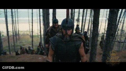 Man In Helmet Walking Through Forest With Others GIF