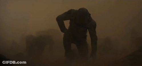 Man In Helmet Walking Through Sandstorm GIF