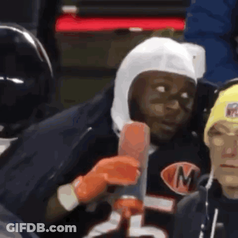 Man In Helmet With M Holding Hot Dog GIF