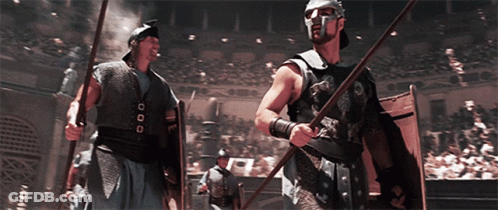 Man In Helmet With Spear And Shield Before Crowd GIF