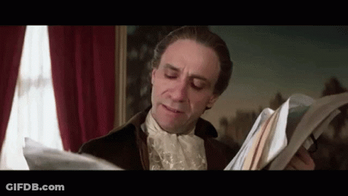 Man In Historical Costume Holding Papers GIF